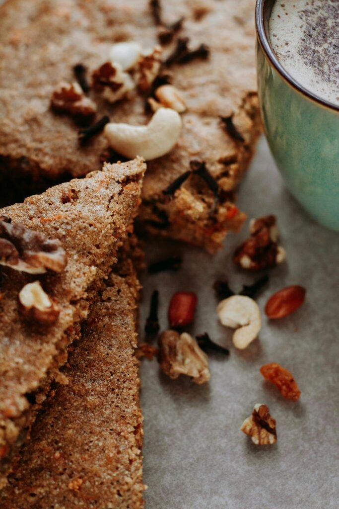 Close-up of nutty baked treats paired with a creamy coffee, perfect for indulgence.
