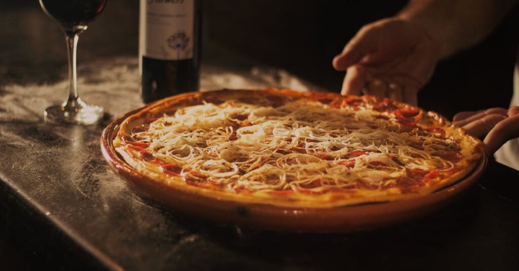 Delicious pepperoni pizza paired with red wine, showcasing a rustic dining experience in Centro, RJ.