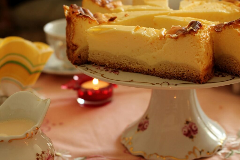 A rustic cheesecake slice on a floral plate with a cozy ambiance.